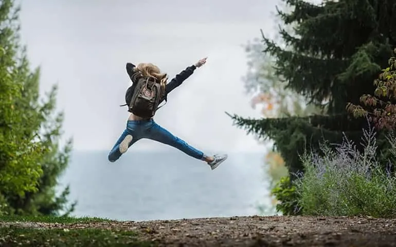 Person jumping joyfully outdoors