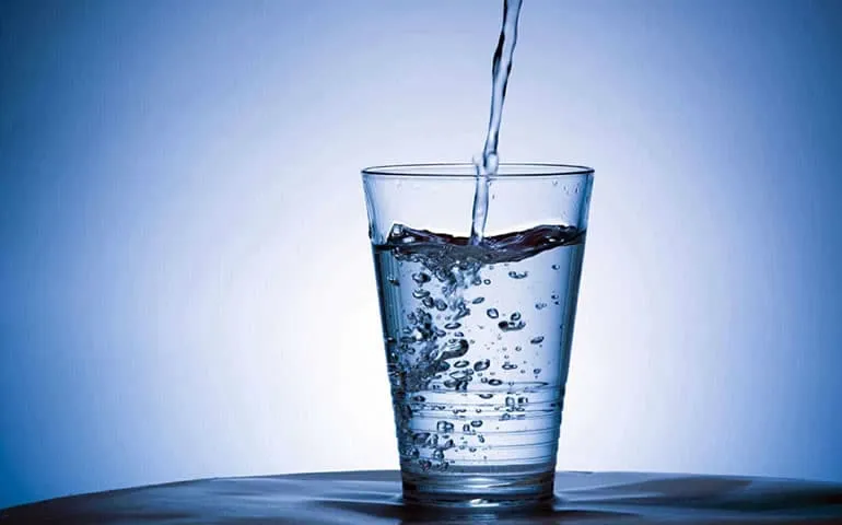 Glass being filled with water