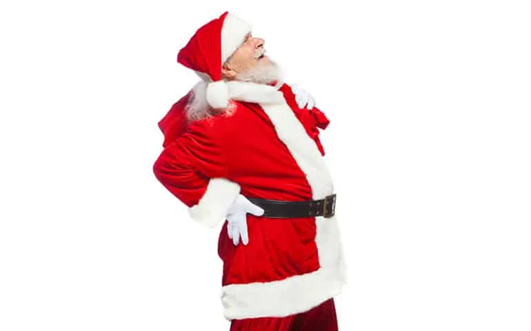 Santa Claus holding his lower back in pain