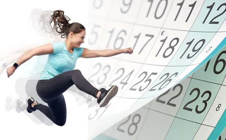 Woman jumping energetically in front of a calendar graphic