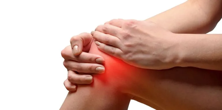 Close-up of hands holding a knee with a highlighted area of pain