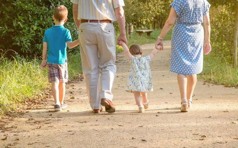Family walking together outdoors on a sunny day