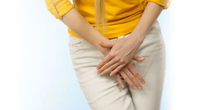 Woman holding her hands over her lower abdomen