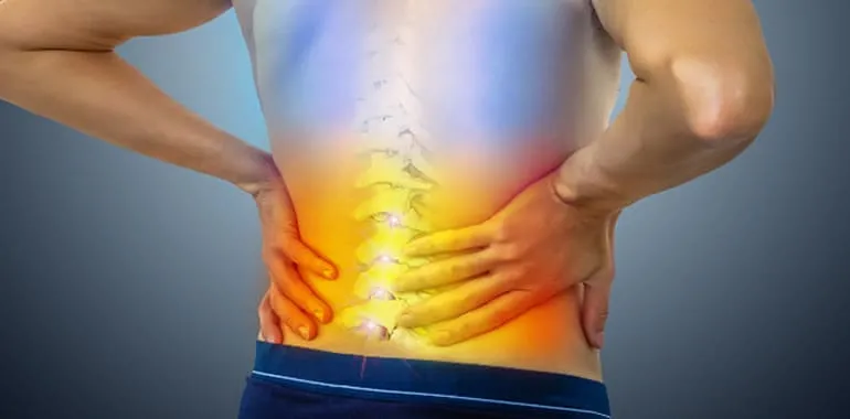 Close-up of a person's lower back with a highlighted area of pain