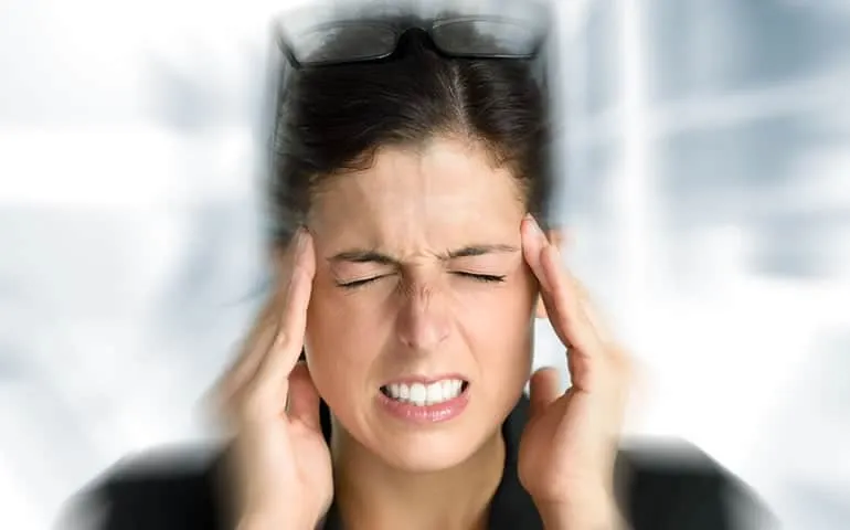 Woman holding her temples in stress or pain