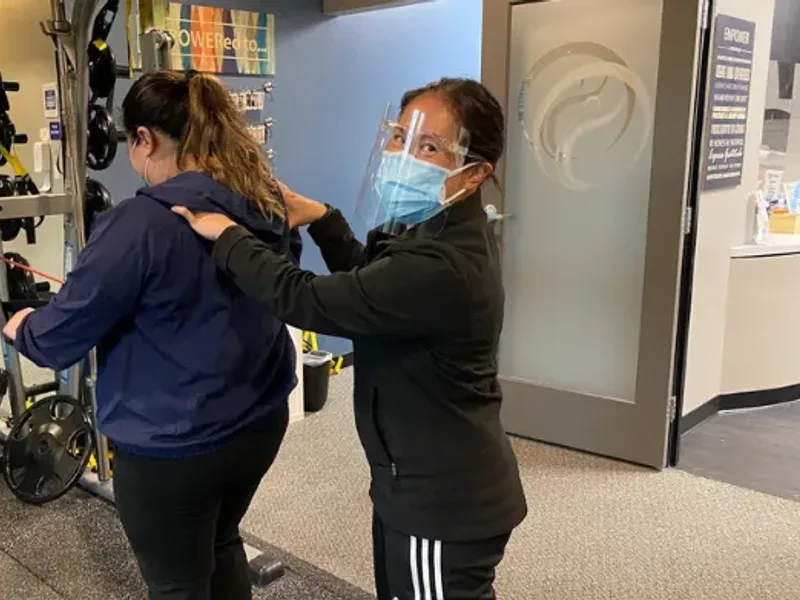 Physical therapist examining a patient's wrist and arm