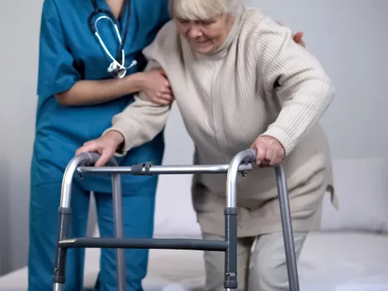 Physical therapist guiding a patient through hip replacement recovery