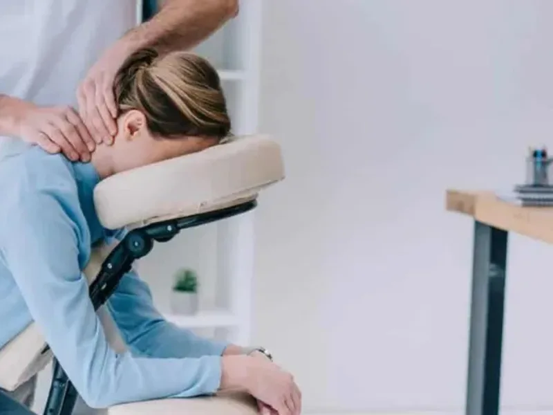 Physical therapist assessing a patient's neck