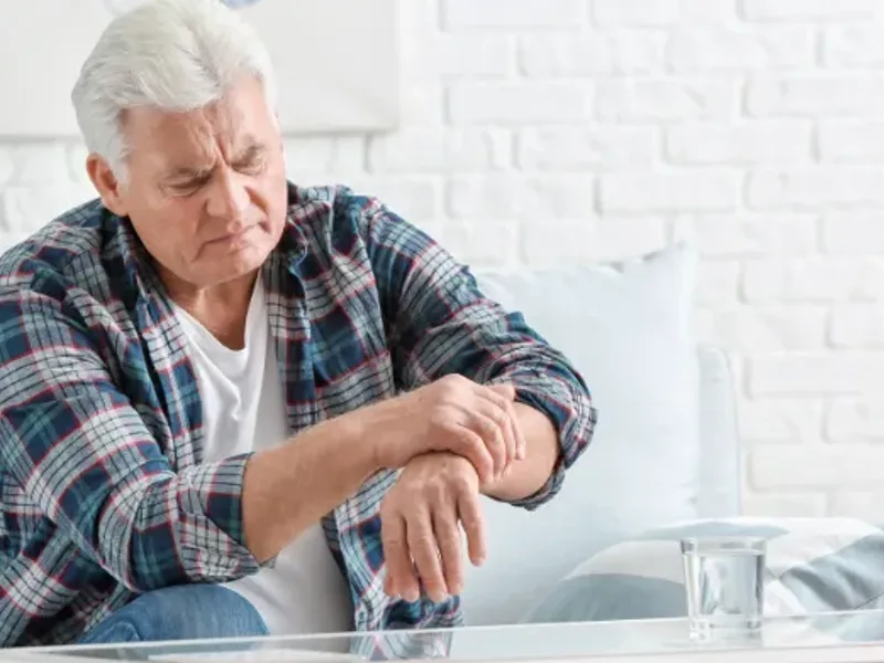 Physical therapist guiding a patient with Parkinson's through movement training