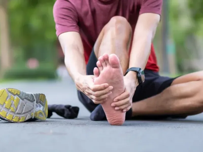 Physical therapist examining a patient's heel and foot