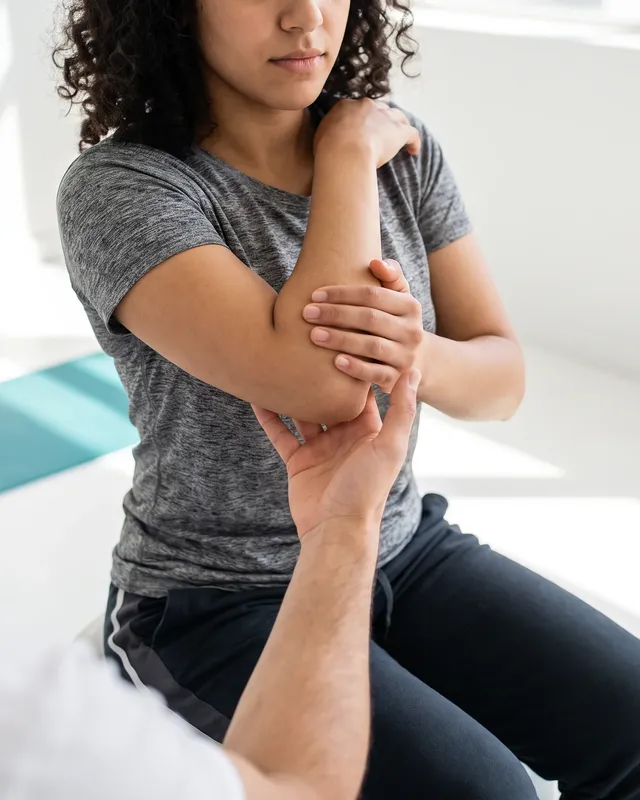 Physical therapist treating a patient's tendon inflammation