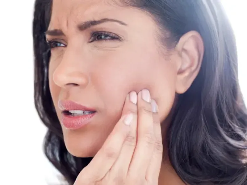 Physical therapist assessing a patient's jaw
