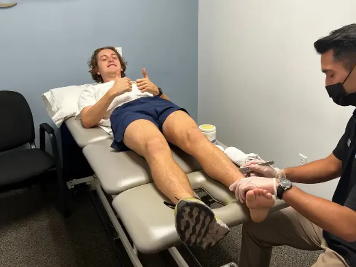 IASTM instrument-assisted soft tissue treatment being performed on a patient
